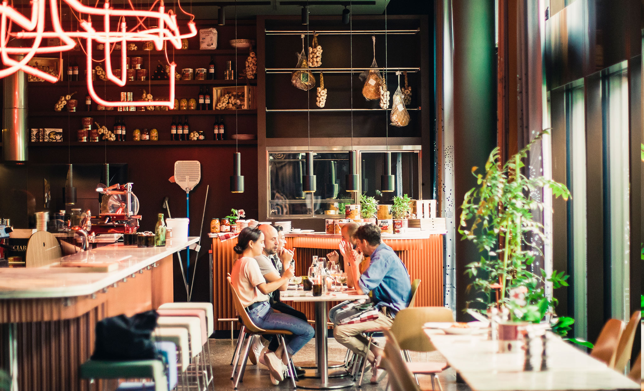 Eine Gruppe Menschen besucht ein italienisches Restaurant in Zürich und sitzt gemeinsam im RIBELLI am Tisch